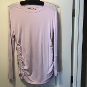 Athleta Women’s Drishti Pink top with ruched sides and thumbholes. Size small.
